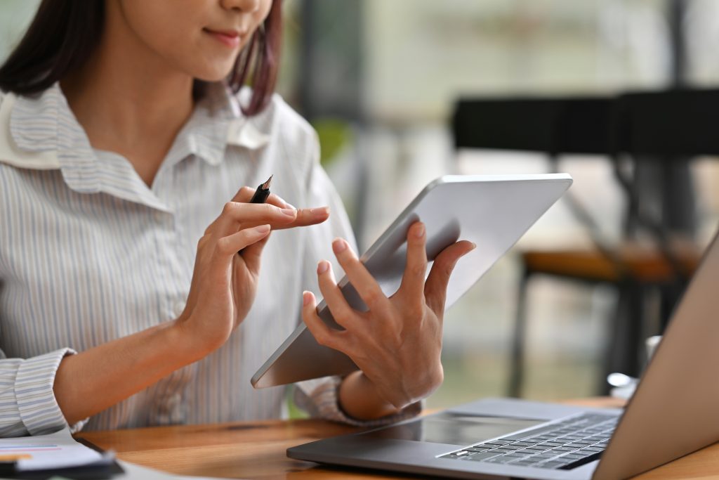 Clinic staff managing medical e-Invoice Malaysia on laptop and tablet