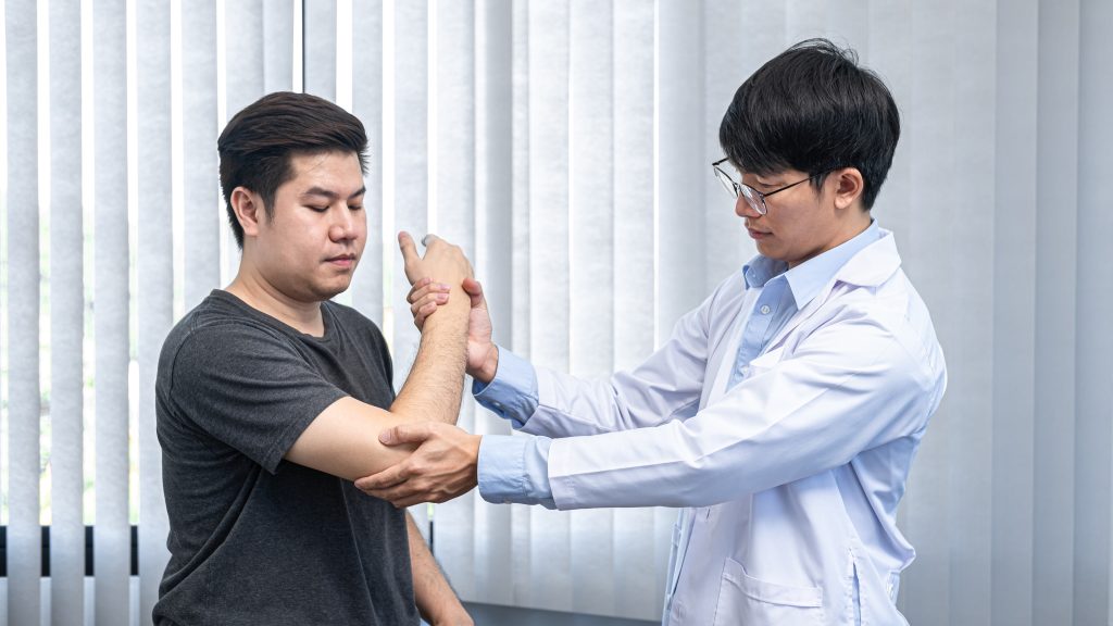 Physiotherapist chiropractor provides treatment to patient