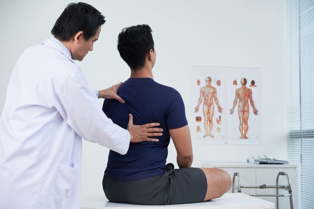 Physiotherapist chiropractor provides treatment to patient